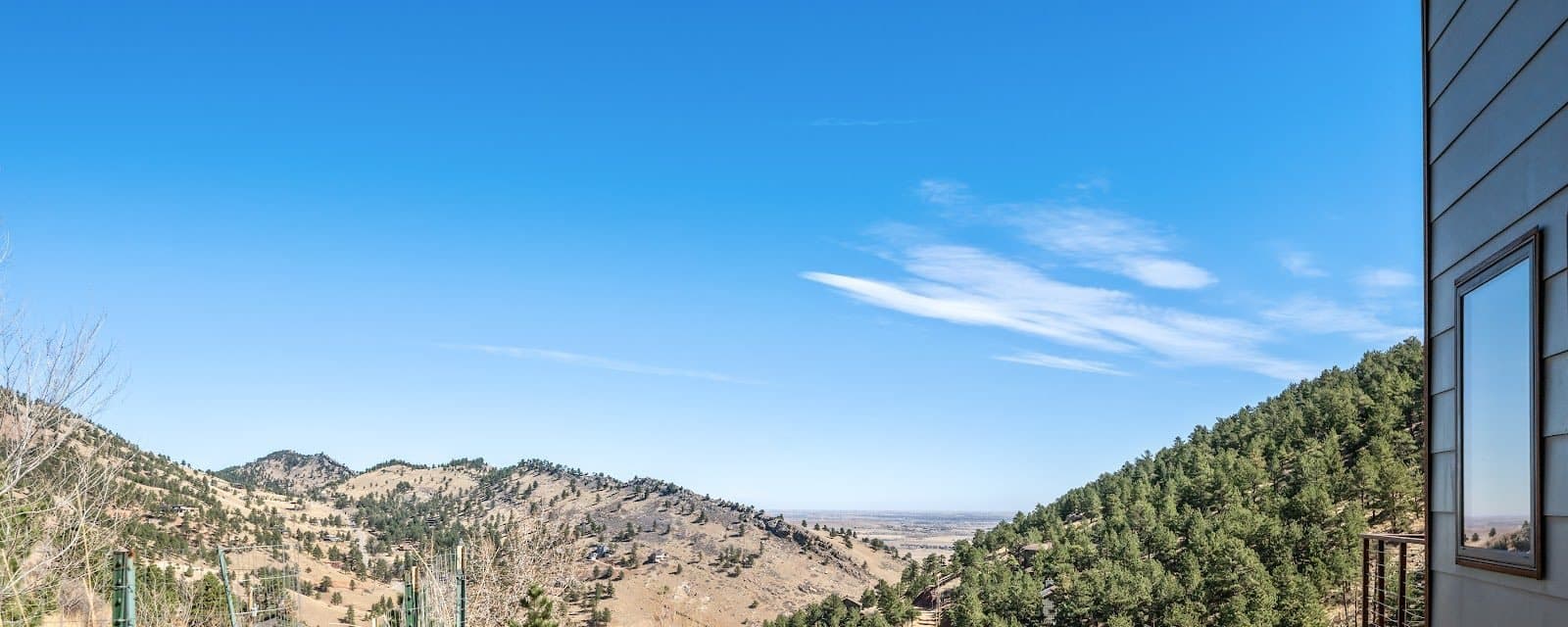 Pine-covered foothills above Boulder under a clear sky